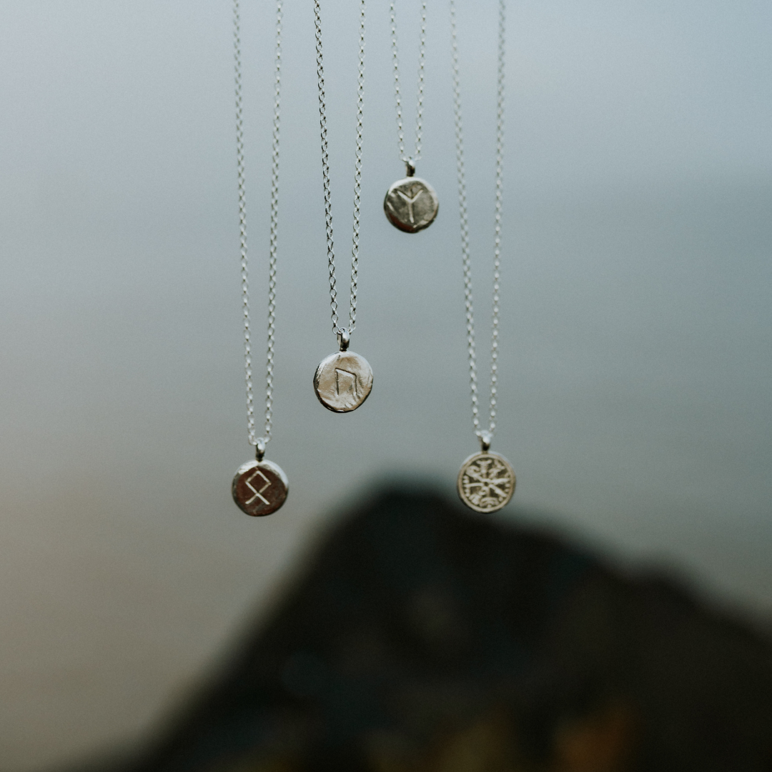 Dusky pink mauve sunset above a firey red sun and black silhouetted pine trees