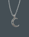 Silver crescent moon necklace with aquamarine trio, symbolic celestial jewellery in recycled sterling silver.