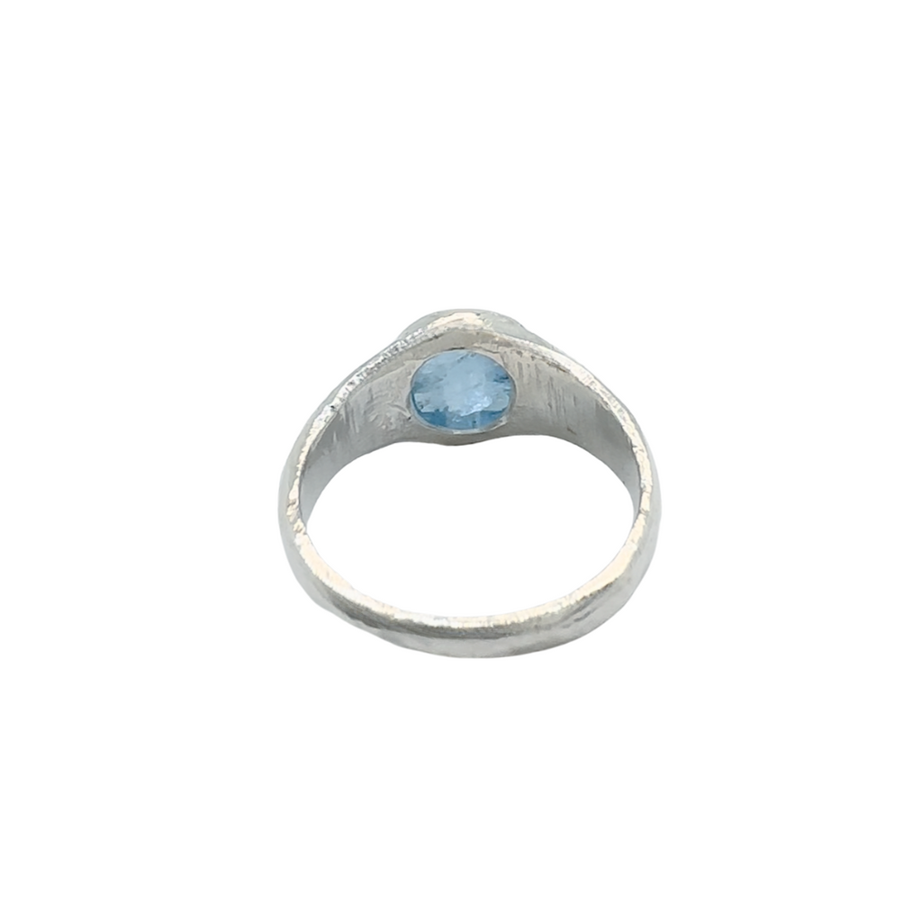 Back view of a sterling silver aquamarine signet ring photographed on a white background.