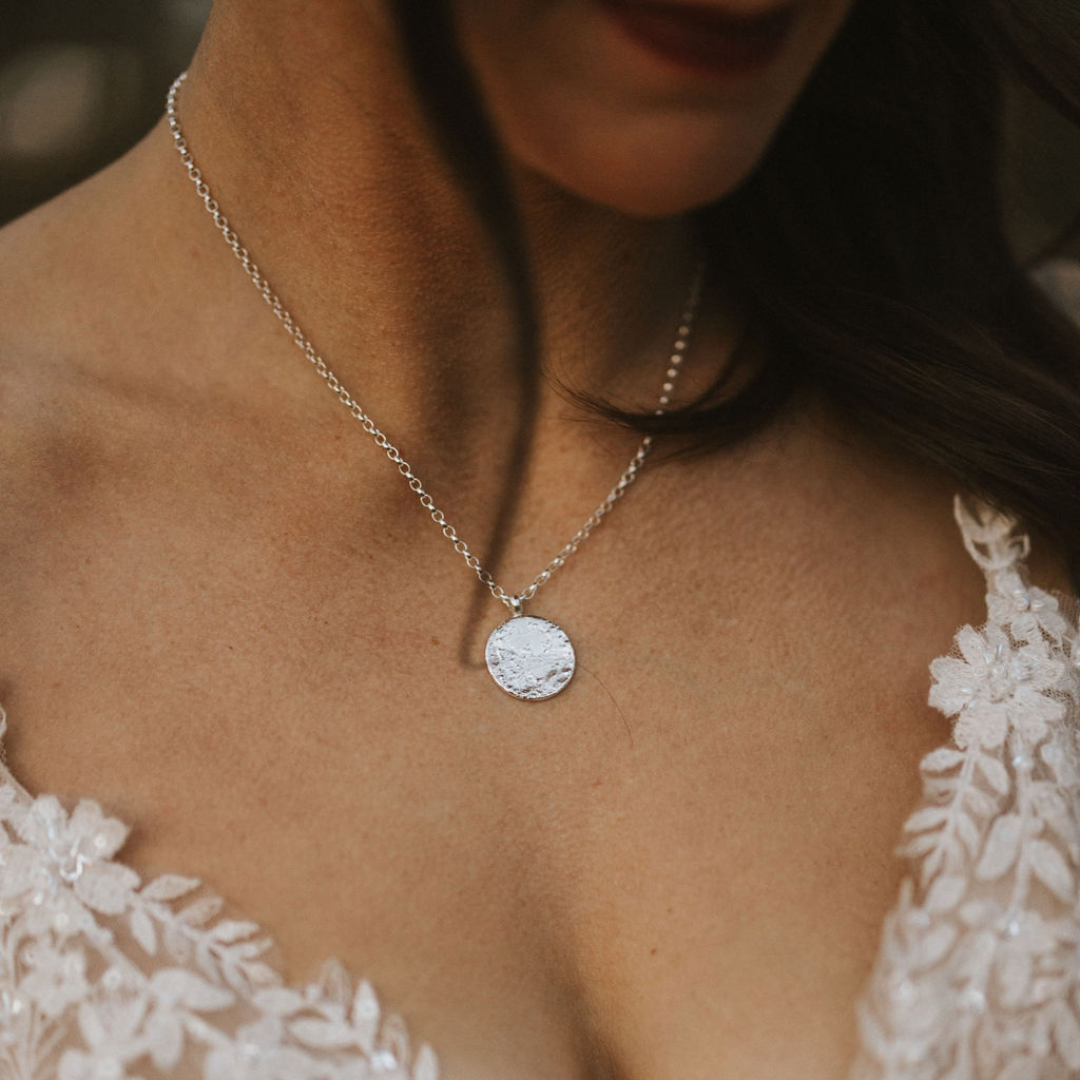 Sterling silver Full Moon necklace on an 18-inch chain worn with a white wedding dress.