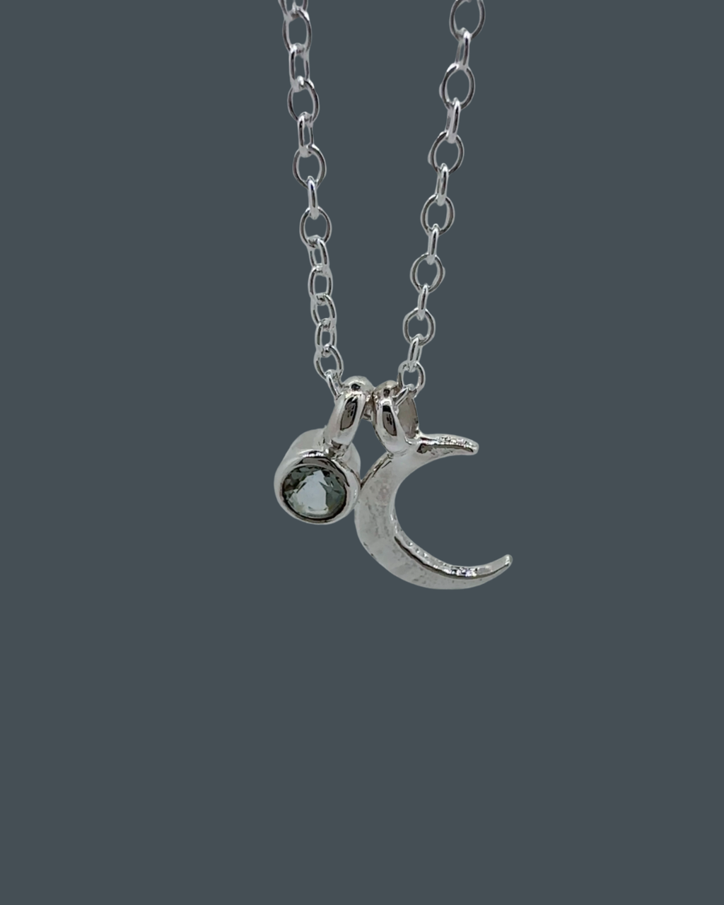 Handmade recycled sterling silver crescent moon necklace with a 5mm aquamarine charm.