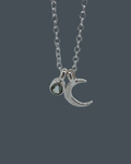 Handmade recycled sterling silver crescent moon necklace with a 5mm aquamarine charm.