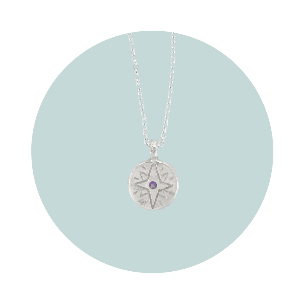 Recycled silver North Star pendant necklace with amethyst February birthstone, flush set to symbolise peace, balance and inner strength.