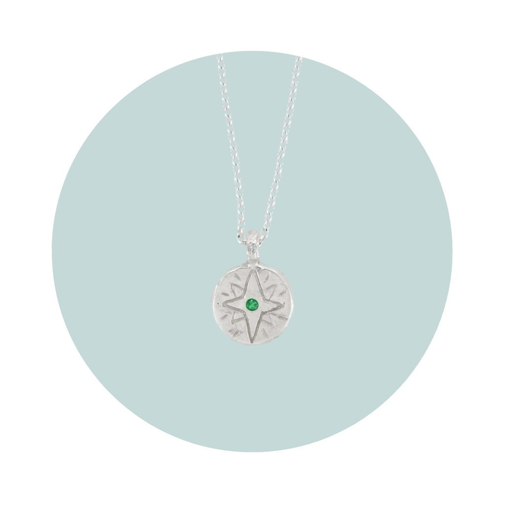 Recycled silver North Star pendant necklace with emerald May birthstone, flush set to symbolise love, healing and growth.