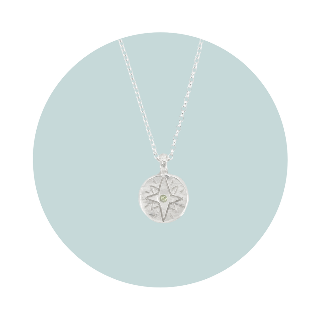 Recycled silver North Star pendant necklace with peridot August birthstone, flush set to symbolise vitality, growth and positivity.