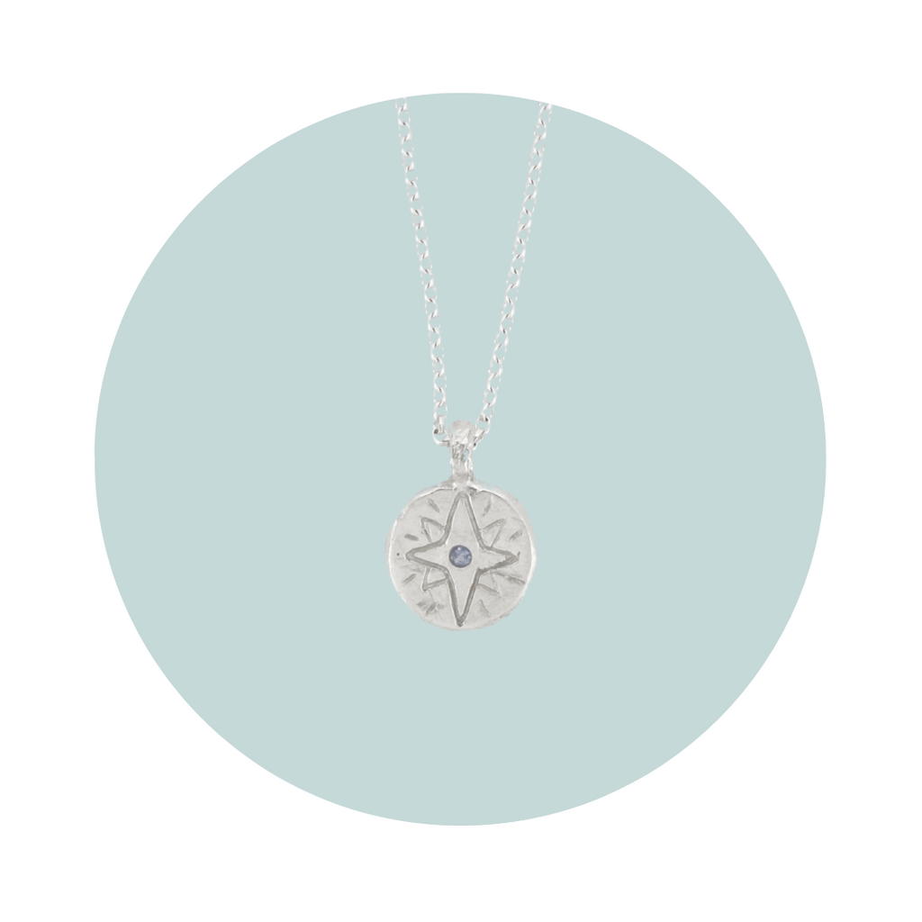 Recycled silver North Star pendant necklace with tanzanite December birthstone, flush set to symbolise transformation, wisdom and spiritual growth.